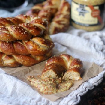 Dijon Stout Soft Pretzels stacked up and eaten with dijon mustard