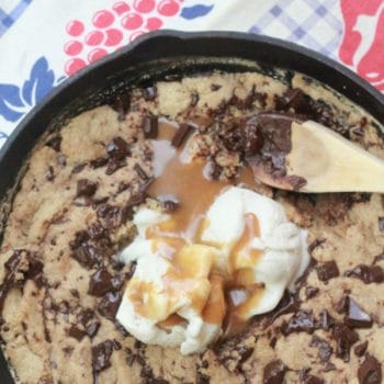 Stylized photo of the salted caramel skillet cookie with ice cream on top.