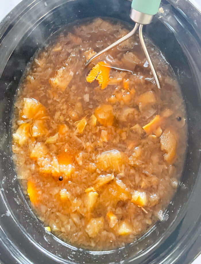 apple cider with the whole fruit in a crock-pot after being cooked