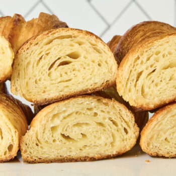 baked croissant cut in half showing all the layers