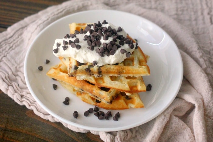 Waffles topped with whipped cream and chocolate chips