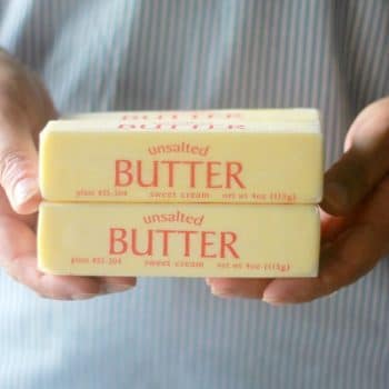 Hands holding sticks of butter