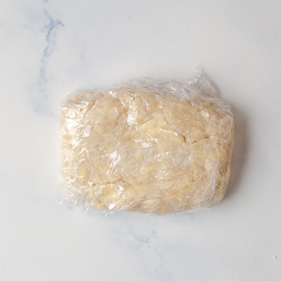 Rough puff pastry dough wrapped in plastic wrap
