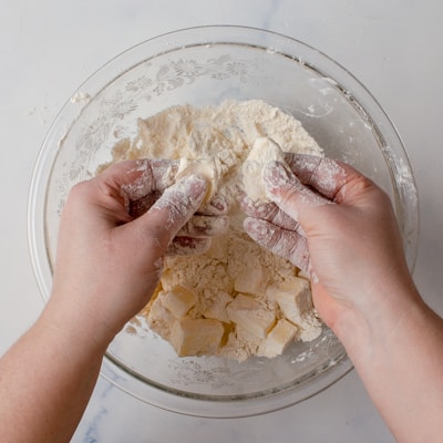 pressing butter cubes into flat pieces