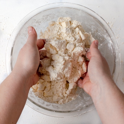 Tossing the water into the mixture with hands