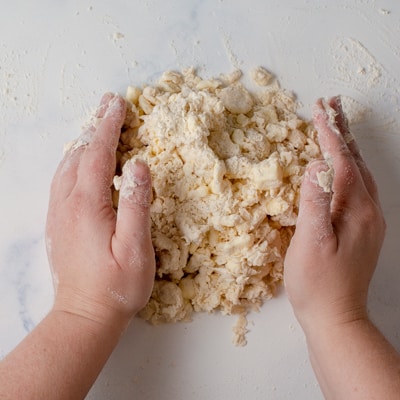 Pressing the quick puff pastry together on the counter