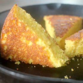 A wedge of cornbread in a skillet