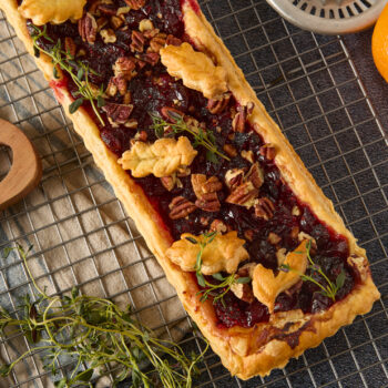 cranberry brie tart topped with leaf shaped pie pieces