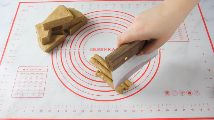 Cutting peppernuts with a bench scraper