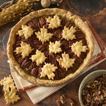a pecan pie toped with pie crust pieces shaped like maple leaves
