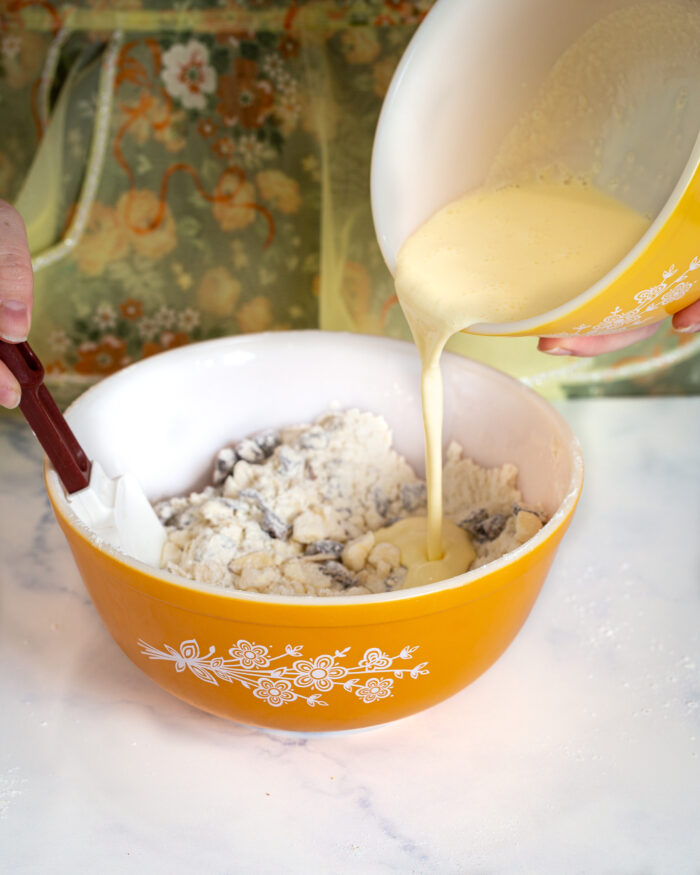adding wet ingredients to dry ingredients