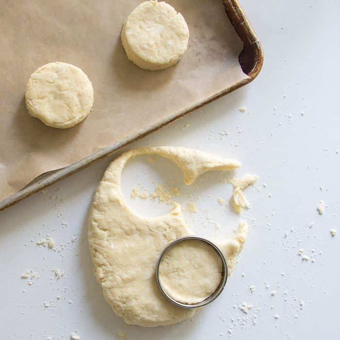 Scone dough being stamped out with a cutter