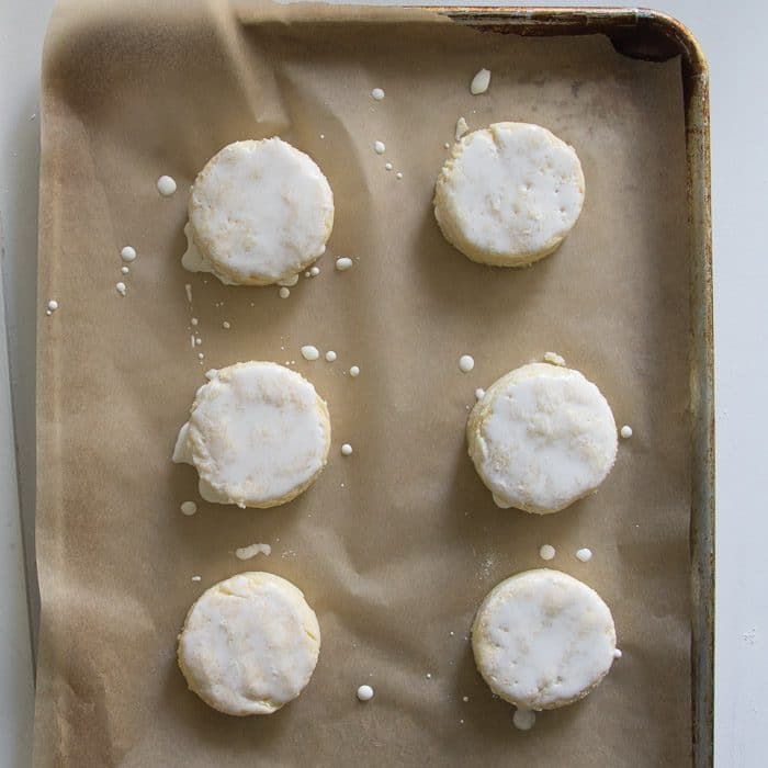 Round raw scones on baking sheet