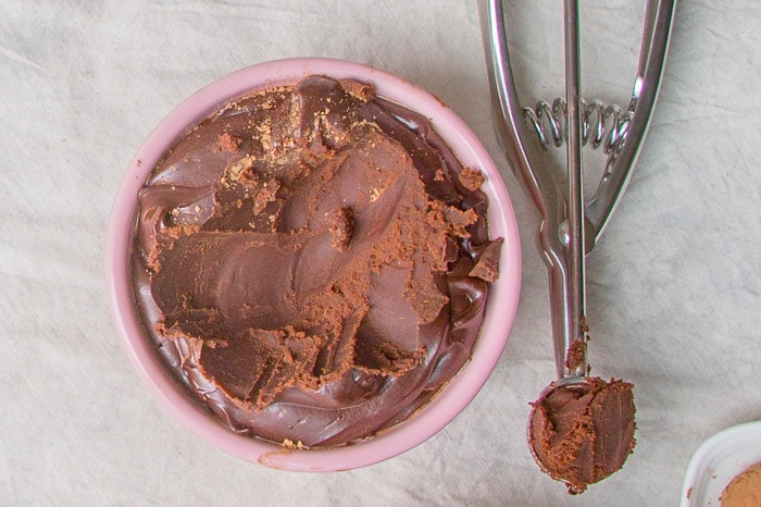 This is a recipe for French chocolate truffles, which is a very simple yet decadent dessert. This style of dessert truffles are made with only three ingredients: melted chocolate, cream, and cocoa powder. Learn the process of how to make chocolate truffles for an easy yet impressive dessert! Ganache being scooped into truffles