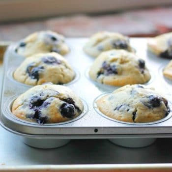 Blueberry muffins after being baked in a muffin tin