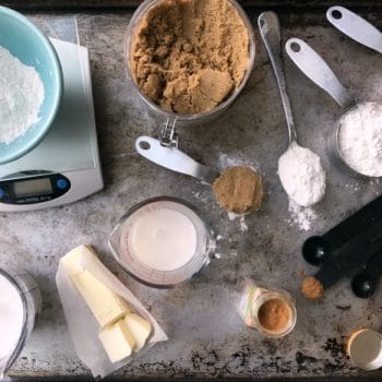 Various ingredients, dry and wet measuring cups and spoons and a scale