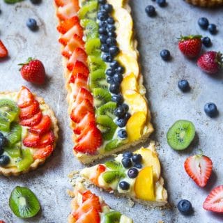 Fruit tart with custard and strawberries, kiwi, blueberries, and peaches