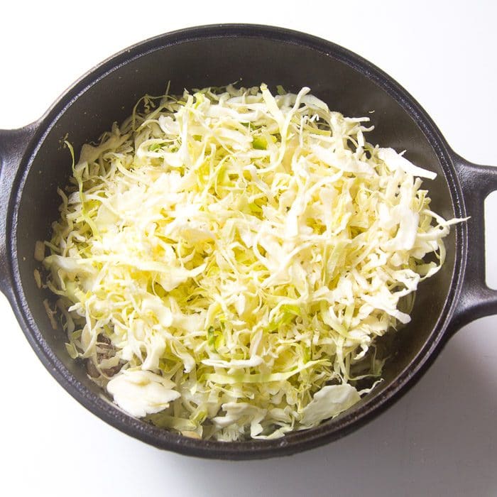 Cabbage and salt added to the pan