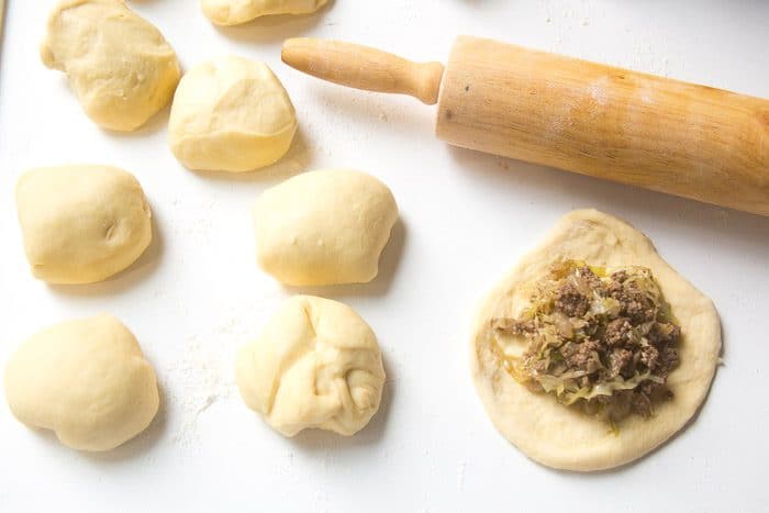 Filling spooned onto a flattened round piece of dough