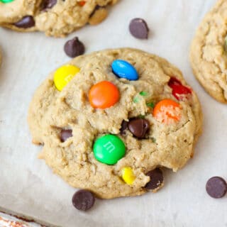 Monster Cookies filled with chocolate chips, nuts and M&Ms on a sheet tray