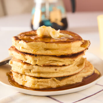 souffle pancakes stacked up with syrup and butter