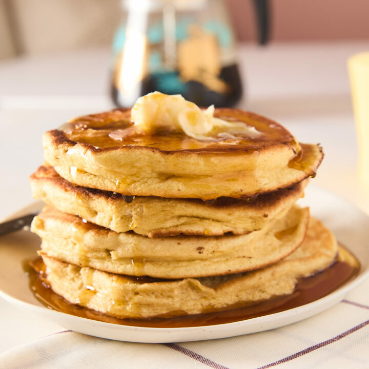 souffle pancakes stacked up with syrup and butter