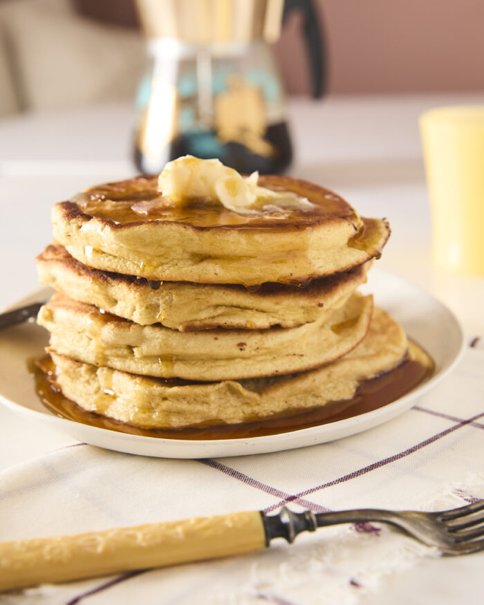 souffle pancakes stacked up with syrup and butter