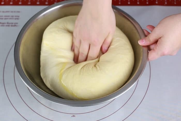 punching down the white sandwich dough