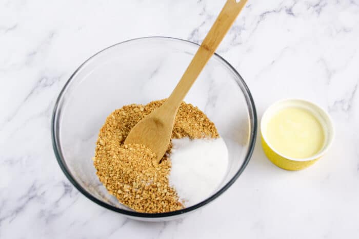 Graham cracker crumbs and sugar in a bowl for graham cracker crust