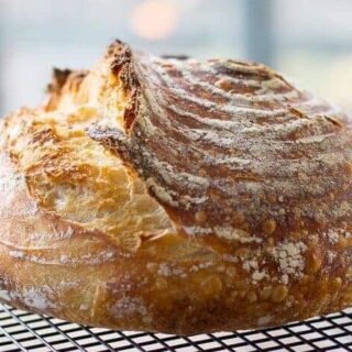 Loaf of no-knead sourdough in dutch oven after being baked