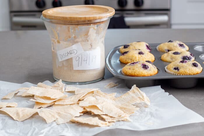 Muffins made from sourdough discard, crackers made from sourdough discard, a jar of sourdough discard