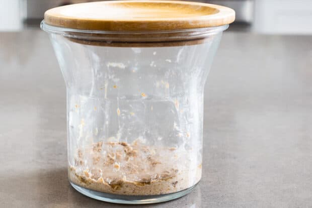 Sourdough jar on day 2 with a bit of hooch on top
