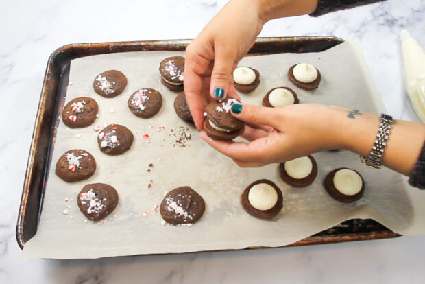 Closing the two whoopie pie ends together, sandwiching the peppermint filling