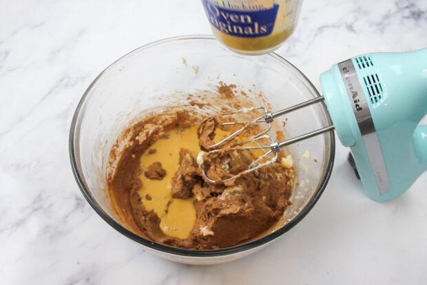 Half of the wet ingredients added into the mixing bowl for the chocolate whoopie pies