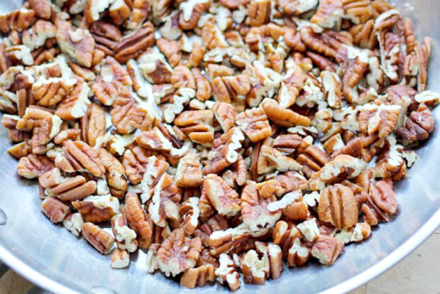 Skillet filled with pecans to be toasted