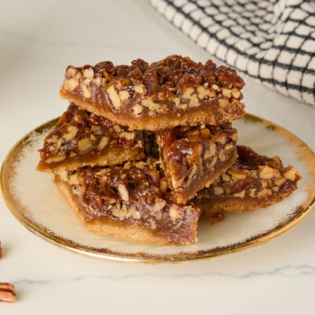 pecan shortbread diamonds stacked on top of each other on a plate