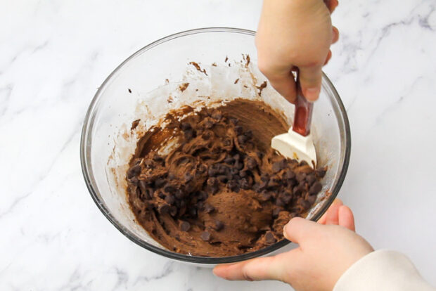 Folding in chocolate chips into the spicy chocolate cookie dough