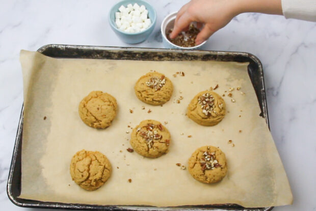 Topping the baked sweet potato cookies with pecans