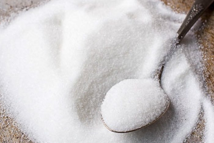 A spoonful of white granulated sugar