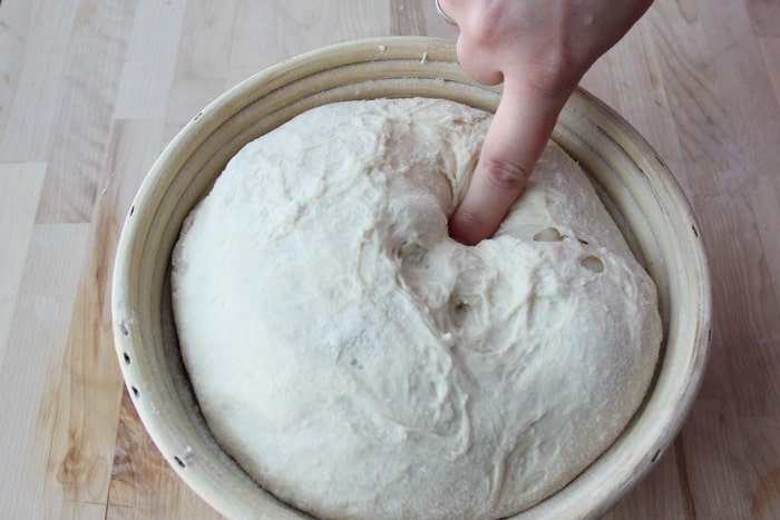 Pressing a finger into the dough ball to see if it's proofed enough