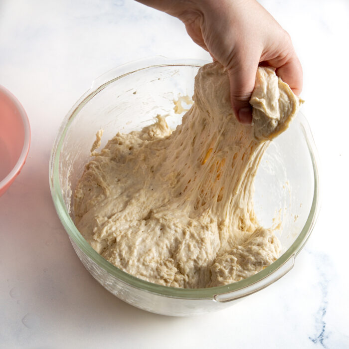 stretching the dough in the bowl