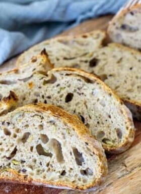 Slices of sourdough bread lined up on a wooden cutting board