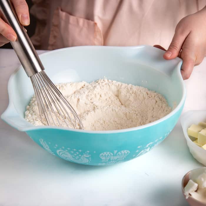 Whisking dry ingredients together in bowl for crust