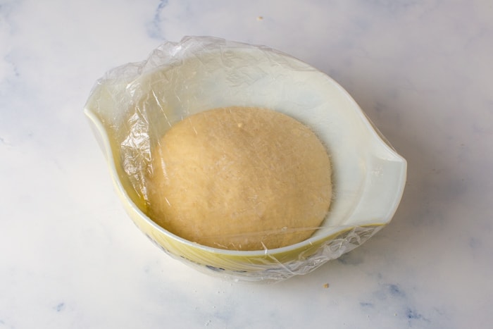 sourdough cinnamon roll dough in bowl after bulk fermenting, it is double in size