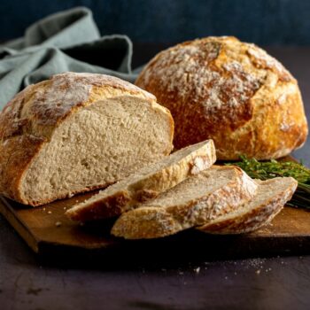 2 round loaves of bread one has a few slices cut