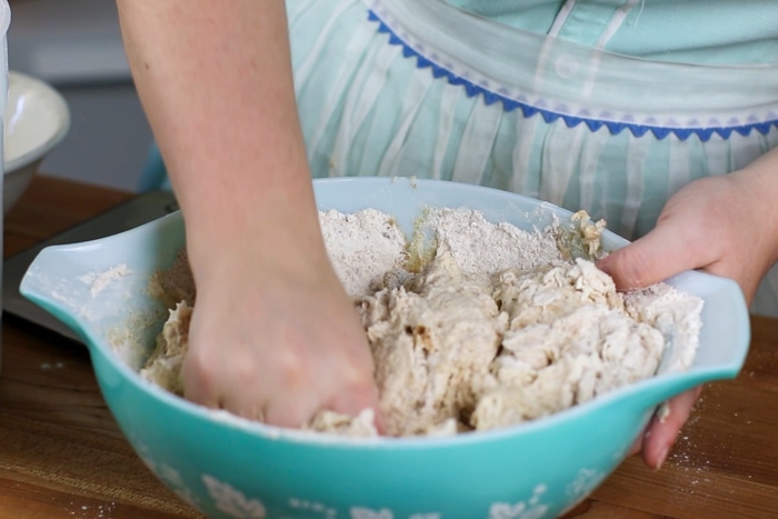 Hand mixing honey wheat sourdough by hand
