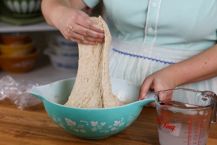 Stretching and folding the dough for honey wheat sourdough sandwich bread