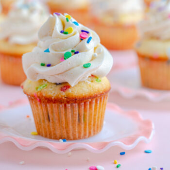 Yellow cupcake with russian buttercream and sprinkles