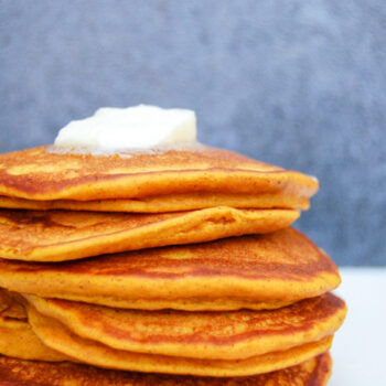 A stack of pumpkin pancakes and butter