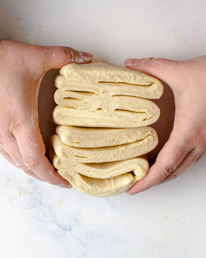 Holding a cross section of quick puff pastry showing the layers that have been created in the dough